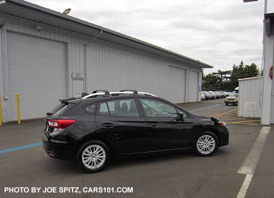 crystal black 2017 Subaru Impreza Premium 5 door hatchback has silver roof rails and 16" alloy wheels.