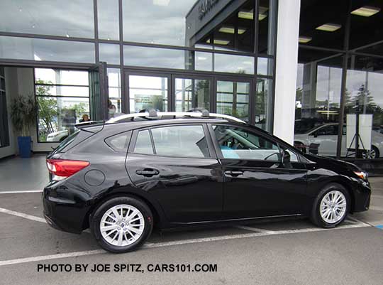 crystal black 2017 Subaru Impreza Premium 5 door hatchback has silver roof rails and 16" alloy wheels.