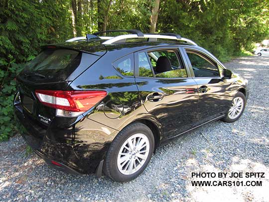 crystal black 2017 Subaru Impreza Premium 5 door hatchback has silver roof rails and 16" alloy wheels.