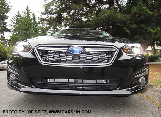 crystal black 2017 Subaru Impreza Limited with silver fog light trim, silver grill accent bar with logo. Limited shown with active grill shutter open.