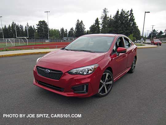 2017 Subaru Impreza Sport 4 door sedan, 18" alloys, black rear spoiler. lithium red pearl shown.