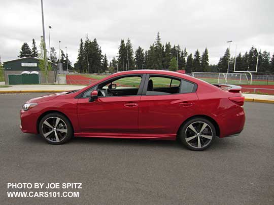 side view 2017 Subaru Impreza Sport 4 door sedan, 18" alloys, black rear spoiler. lithium red pearl shown.