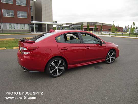 2017 Subaru Impreza Sport 4 door sedan, 18" alloys, black rear spoiler with body colored ends. lithium red pearl shown.