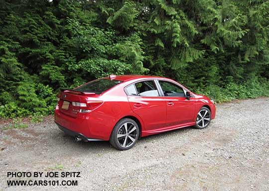 2017 Subaru Impreza Sport 4 door sedan, 18" machined alloys, black rear spoiler with body colored ends. lithium red pearl shown.