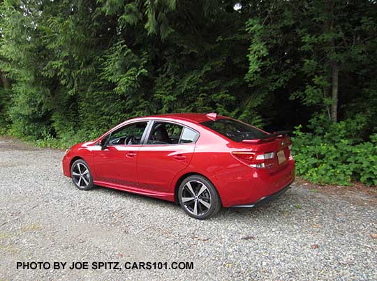 2017 Subaru Impreza Sport 4 door sedan, 18" machined alloys, black rear spoiler with body colored ends. lithium red pearl shown