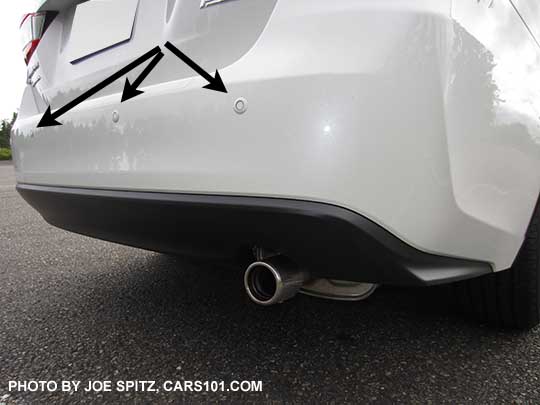2017 Subaru Impreza Limited sedan showing 3 of the 4 reverse auto brake sensors (RAB) and stainless exhaust tip. Crystal white shown