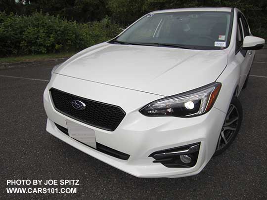 2017 Subaru Impreza Limited 4 door sedan has chrome fog light accents, 17" machined alloys, body colored mirrors with turn signals. Shown with optional Sport mesh grill.