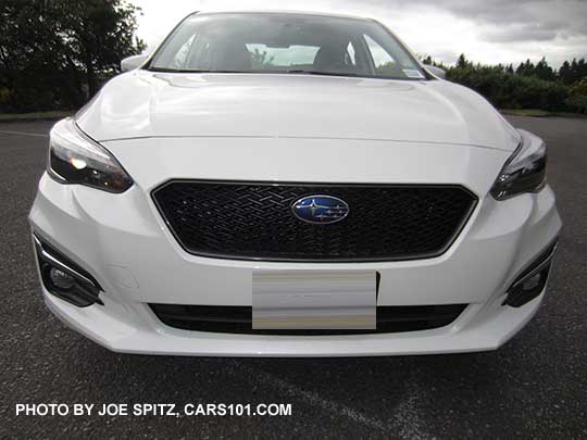 2017 Subaru Impreza Limited 4 door sedan has chrome fog light accents. Shown with optional Sport mesh grill.