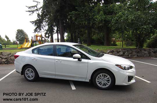 2017 Subaru Impreza Premium 4 door sedan with 16" silver alloys, body colored door handles and mirrors. Crystal white shown.