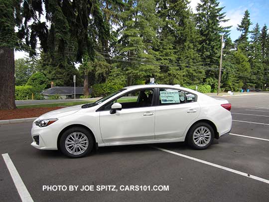 2017 Subaru Impreza Premium 4 door sedan with 16" silver alloys, body colored door handles and mirrors. Crystal white shown.