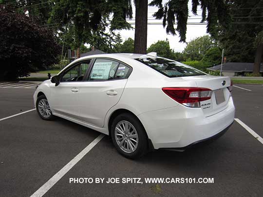 2017 Subaru Impreza Premium 4 door sedan with 16" silver alloys, body colored door handles and mirrors. Crystal white shown.