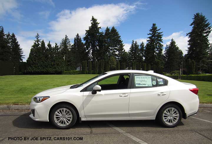 2017 Subaru Impreza Premium 4 door sedan with silver 16" alloys, body colored handles and outside mirrors. Crystal white shown.