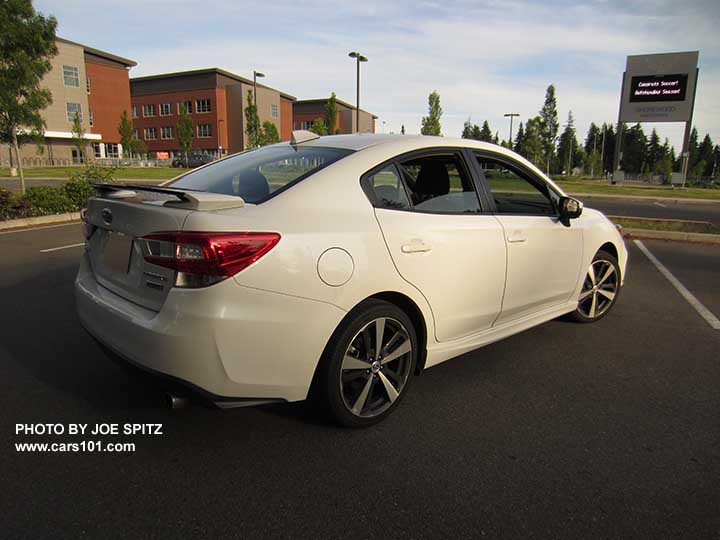 2017 Subaru Impreza Sport 4 door sedan with 18" machined alloys, black rear spoiler with body colored supports, body colored door handles