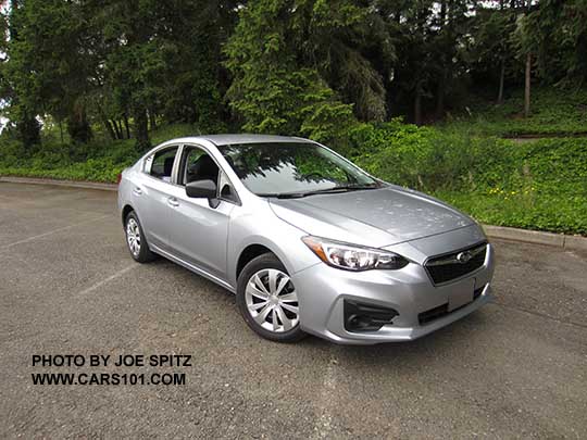 2017 Subaru Impreza 2.0i 4 door sedan, with black outside mirrors, 16" wheels with plastic wheel covers, no fog lights. Ice silver shown.