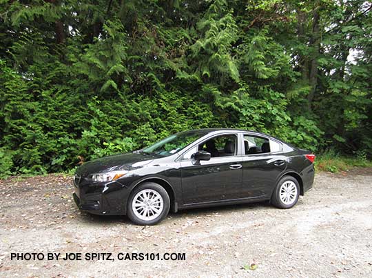 side view 2017 Subaru Impreza Premium 4 door sedan, silver alloy wheels, crystal black color shown.