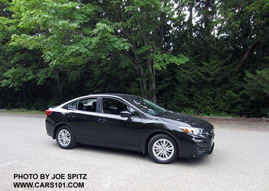 2017 Subaru Impreza Premium 4 door sedan, silver alloy wheels, crystal black color shown.