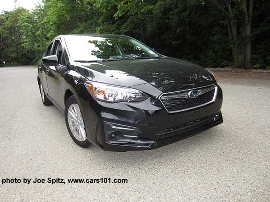 2017 Subaru Impreza Premium 4 door sedan, silver alloy wheels, no fog lights, crystal black color shown.