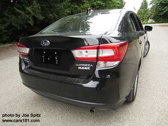 rear view 2017 Subaru Impreza Premium 4 door sedan, silver alloy wheels, no exhaust tip, crystal black color shown.