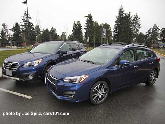 2017 Subaru Lapis Blue Impreza Limited 5 door hatchback alongside of a Lapis Blue Outback Limited