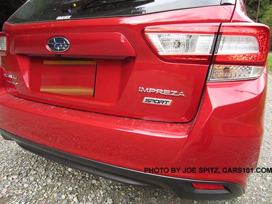 closeup of the rear Sport logo on a 2017 Subaru Impreza Sport 5 door hatchback, Lithium Red Pearl Color