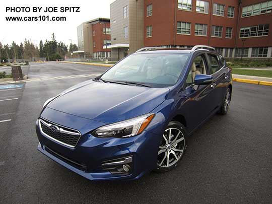 2017 Subaru Impreza Limited 5 door hatchback, 17" machined alloys, silver roof rack rails and fog light trim. Lapis Blue color