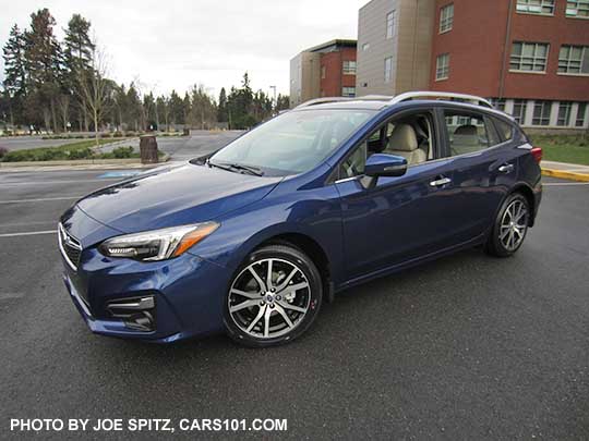 2017 Subaru Impreza Limited 5 door hatchback, 17" machined alloys, silver roof rack rails, door handles, and fog light trim. Lapis Blue color