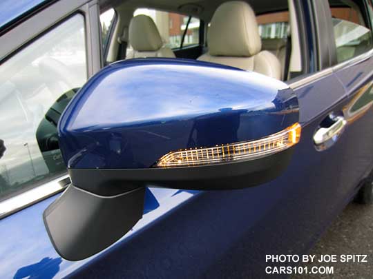 2017 Subaru  Impreza Limited 5 door hatchback body colored outside mirror with integrated turn signals, and bright lower window trim. Lapis blue car.