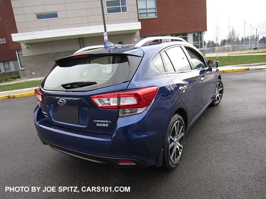 rear view 2017 Subaru Impreza Limited 5 door hatchback has silver roof rack rails.  17" machined alloys. Lapis blue color.