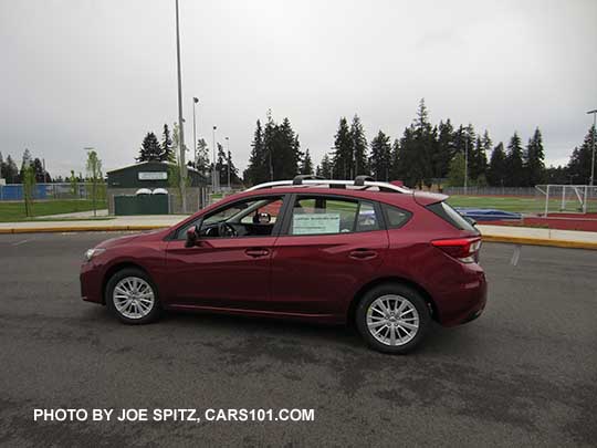 2017 Subaru Impreza Premium 5 door hatchback, 16" silver alloys, silver roof rack rails. Venetian Red car shown with optional cross bars.