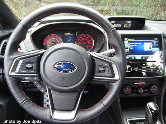 2017 Subaru Impreza Sport has a leather wrapped steering wheel with red stitching, red dash gauges,  8" audio with single CD player.