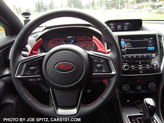 2017 Subaru Impreza Sport steering wheel with aftermarket, larger paddle shifters, and red center Subaru Pleiades logo