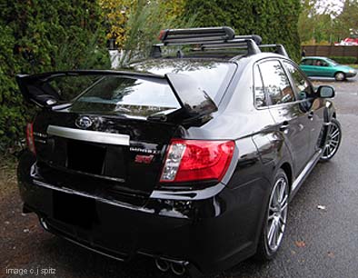 2011 Subaru STI 4 door sedan with optional roof rack and ski attachment