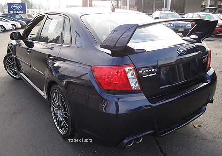 2011 Subaru STI 4 door sedan with optional roof rack and ski attachment