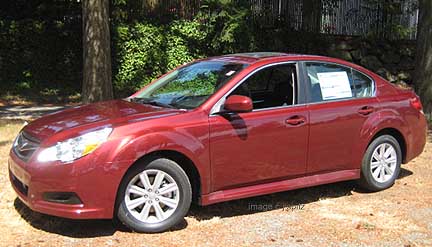 2010 Subaru Legacy premium sedan, side view, ruby red shown