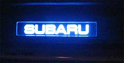 illuminated sill plate, light blue 'Subaru' glows at night