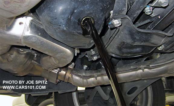 draining dirty oil from a Subaru