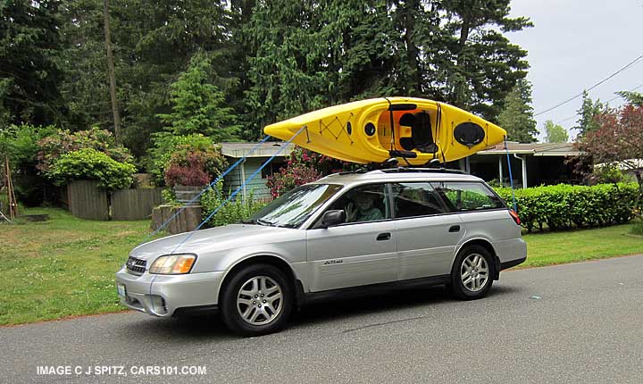 2004 silver subaru outback with 2 kayaks on the roof racks