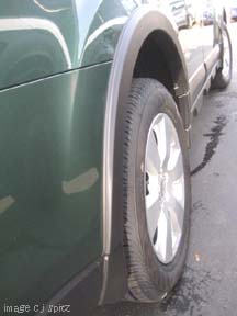 close up of wheel arch moldings on 2010 outback