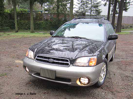 front of the 2002 Outback- shown with headlights and fog lights on