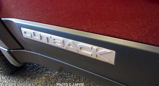 2012 subaru outback side logo, ruby red color shown