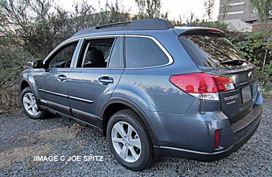 2014 Subaru Outback with body side moldings, wheel arch moldings, twilight blue shown