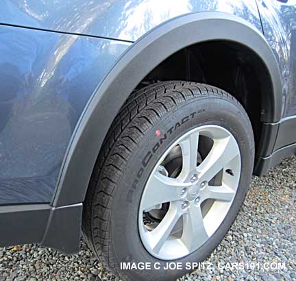close-up of 2014 outback with splash guards, wheel arch moldings