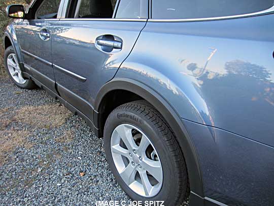 teilight blue subaru outback with wheel arch moldimgs, side moldings