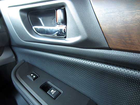 2015 Outback Limiteds have chrome inner door handles and wood trim, passenger door shown