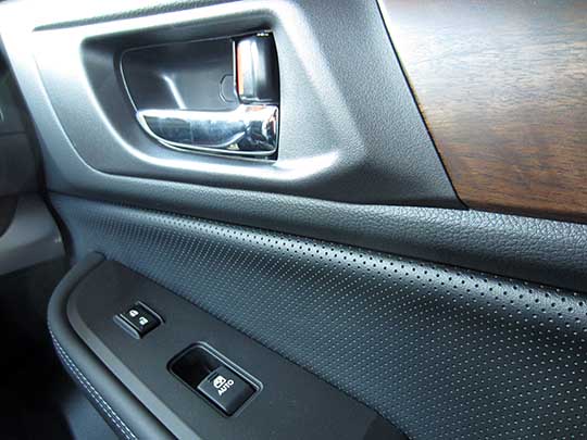 2016 and 2015 Outback Limiteds have chrome inner door handles and wood trim, passenger door shown