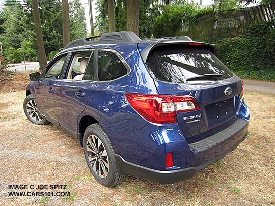 rear view 2015 Subaru Outback Limited comes with 18" alloys, optional rear bumper cover and splash guards.  lapis blue shown