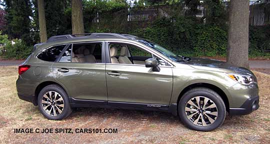 side view 2015 Outback Limited has dark tinted rear glass, wilderness green shown