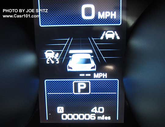 closeup of the 2016 Outback dashboard gauge center LCD display with optional Eyesight active cruise control functions displayed. The 1 bar indicates the following distance from the car in front is at the Minimum distance.  The yellow arrow points at the new for 2016 Lane Keep Assist on symbol that is included with the optional Eyesight system.