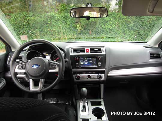 2016 Subaru Outback 2.5i base model with 6.2" audio, textured silver dash trim, black cloth shown.