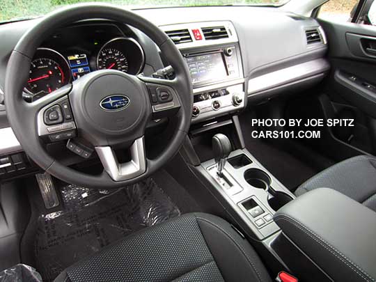 2016 Subaru Outback 2.5i base model with 6.2" audio, textured silver dash trim, black cloth shown.